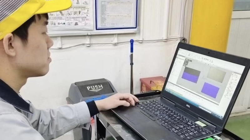Inspector checking quality at factory desk