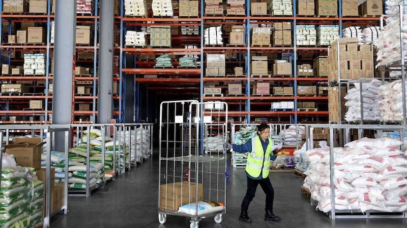 Workers managing inventory inside a China warehouse for export orders