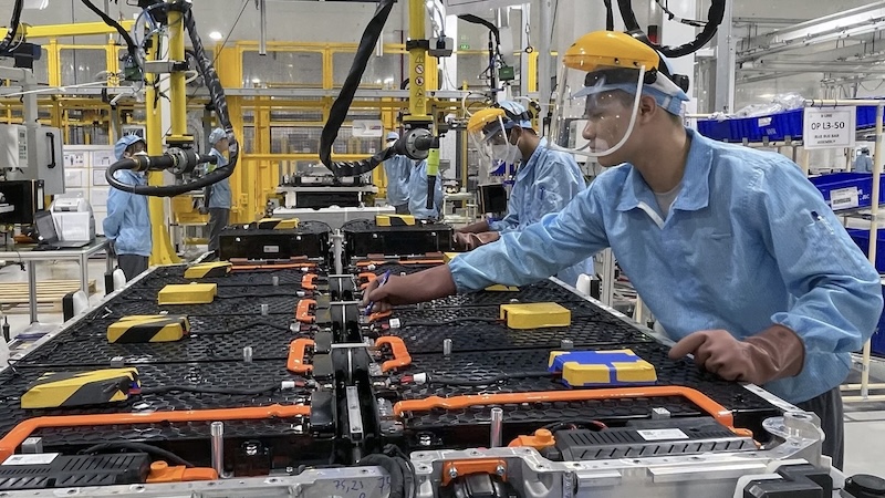 Factory workers on assembly line