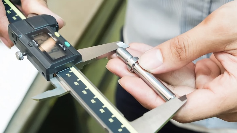 Inspector measuring product dimensions